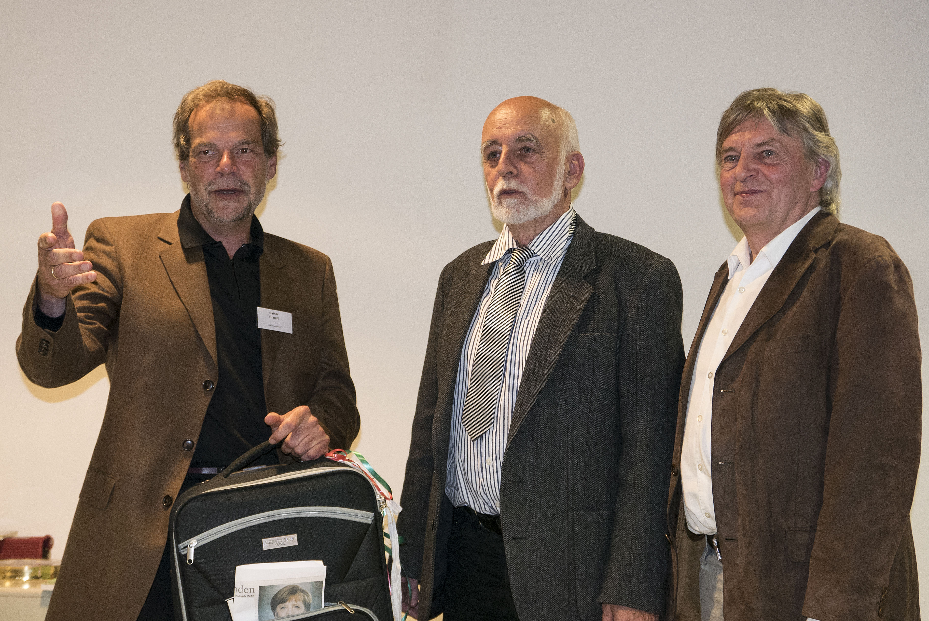 Proviant im Trolley für künftige Reisen überreichten Pfr. Rainer Brandt (links) und der 2. Vorsitzende des Studienzentrums, Gerhard Engel (rechts)